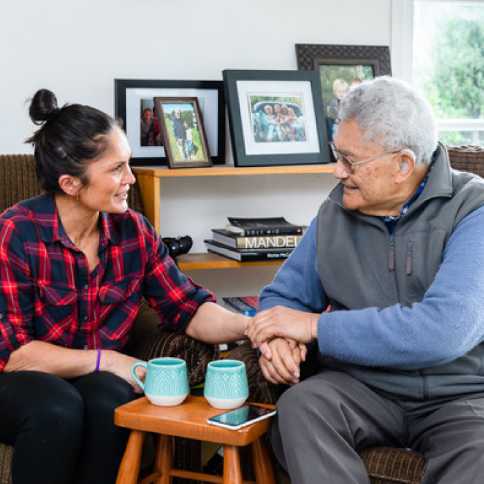 Young Māori lady and an elderly Māori man chatting
